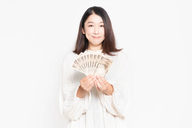 お金を前に差し出す女性