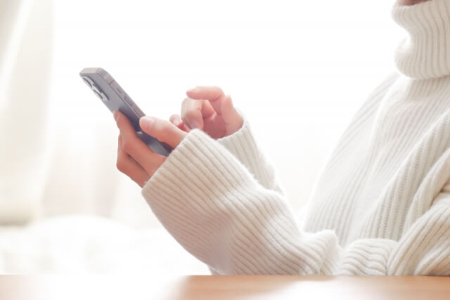 スマホをいじる女性